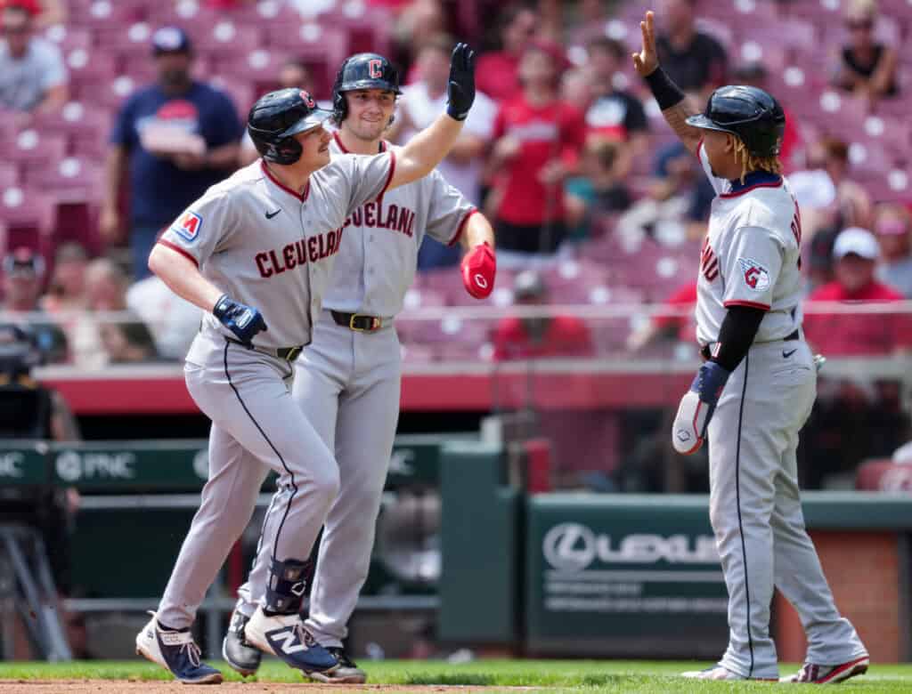 CINCINNATI, OHIO - JULY 28: Kyle Manzardo #9, Chase DeLauter #24, and José Ramírez #11 of the Cleveland Guardians celebrate after Manzardo hit a grand slam in the first inning against the Cincinnati Reds during game one of a doubleheader at Great American Ball Park on July 28, 2026 in Cincinnati, Ohio.