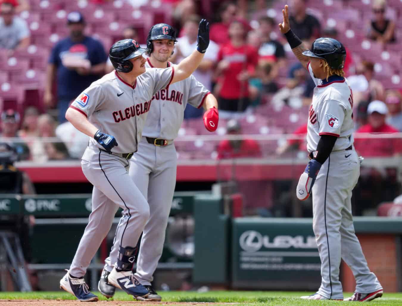 CINCINNATI, OHIO - JULY 28: Kyle Manzardo #9, Chase DeLauter #24, and José Ramírez #11 of the Cleveland Guardians celebrate after Manzardo hit a grand slam in the first inning against the Cincinnati Reds during game one of a doubleheader at Great American Ball Park on July 28, 2026 in Cincinnati, Ohio.