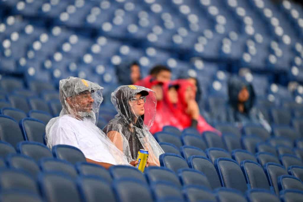 CLEVELAND, OHIO - AUGUST 16: San Diego Padres fans wait during a rain delay before the game against the Cleveland Guardians at Progressive Field on August 16, 2026 in Cleveland, Ohio.