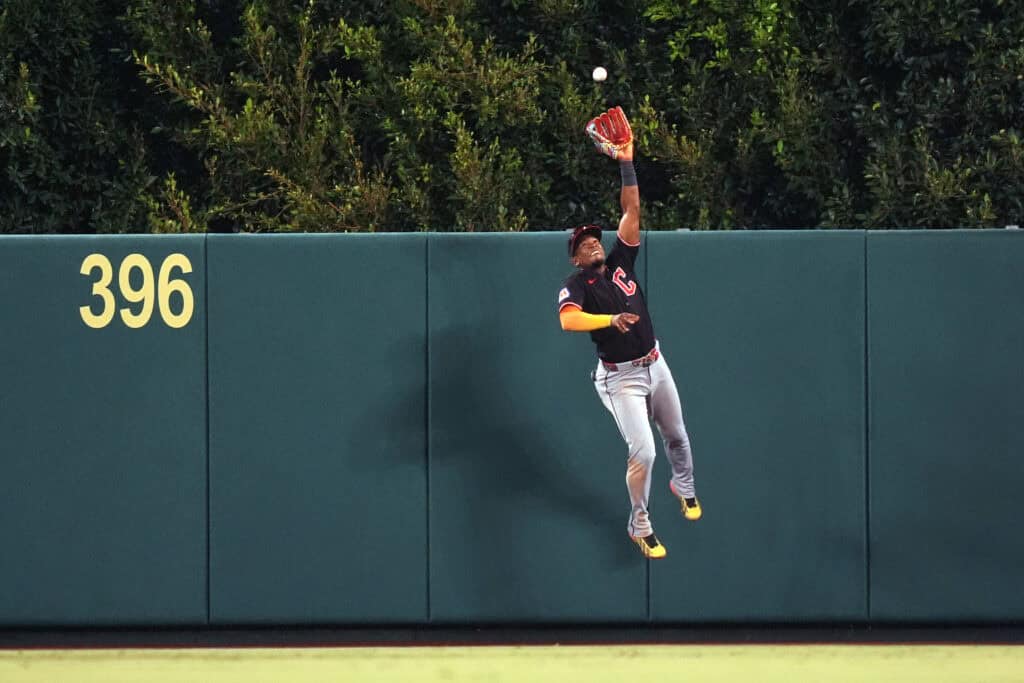 ANAHEIM, CALIFORNIA - AUGUST 25: Center fielder Angel Martinez #1 of the Cleveland Guardians catches a drive at the wall off the bat of Mike Trout of the Los Angeles Angels during the eighth inning at Angel Stadium of Anaheim on August 25, 2026 in Anaheim, California.