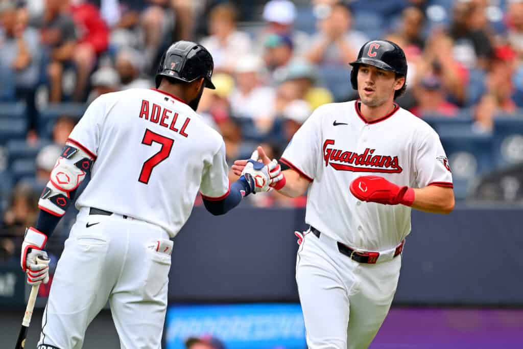 CLEVELAND, OHIO - AUGUST 30: Jo Adell #7 celebrates with Chase DeLauter #24 of the Cleveland Guardians after DeLauter scored during the first inning at Progressive Field on August 30, 2026 in Cleveland, Ohio.
