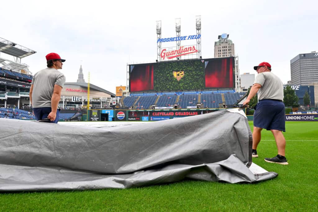 CLEVELAND, OHIO - SEPTEMBER 04: The Cleveland Guardians grounds crew removes the tarp from the field during a rain delay before game one of a doubleheader between the Cleveland Guardians and the Detroit Tigers at Progressive Field on September 04, 2026, in Cleveland, Ohio.