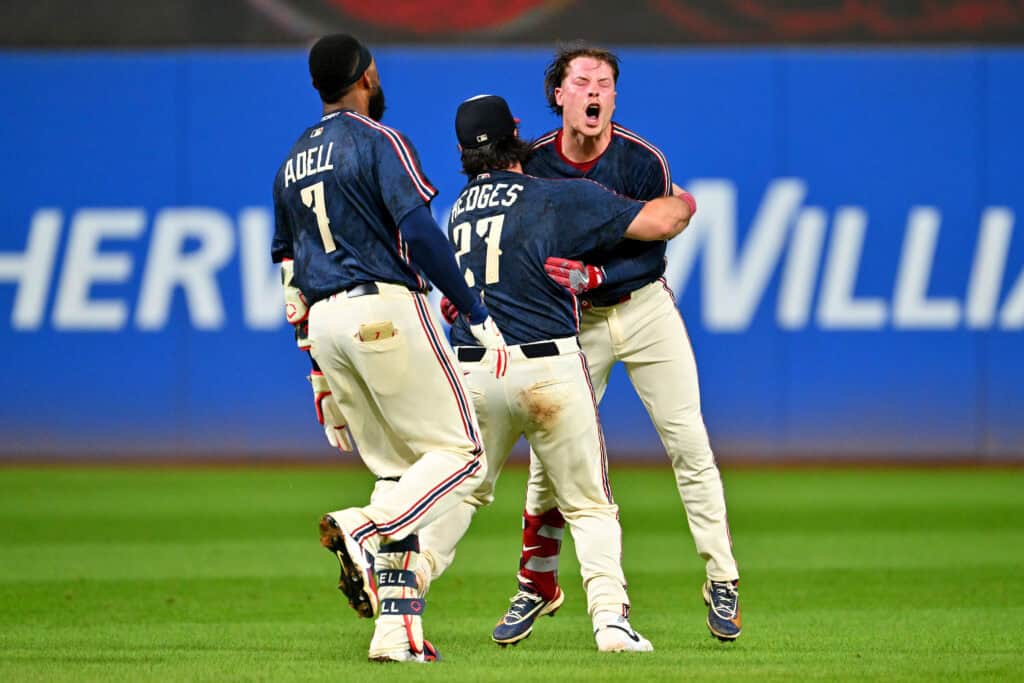 CLEVELAND, OHIO - SEPTEMBER 04: Jo Adell #7 and Austin Hedges #27 celebrate with Travis Bazzana #37 of the Cleveland Guardians after Bazzana hit a walk-off single during the tenth inning of the second game of a doubleheader against the Detroit Tigers at Progressive Field on September 04, 2026, in Cleveland, Ohio. The Guardians defeated the Tigers 4-3 in 10 innings.