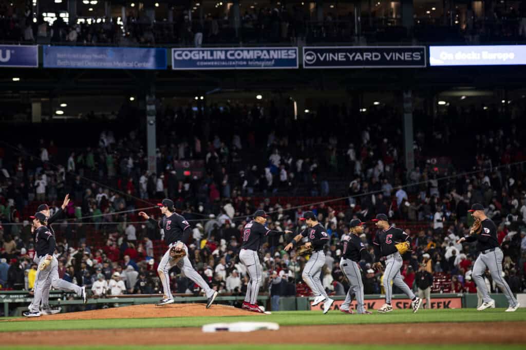 BOSTON, MASSACHUSETTS - SEPTEMBER 22: Members of the Cleveland Guardians high five after their ninth inning win over the Boston Red Sox at Fenway Park on September 22, 2026 in Boston, Massachusetts.