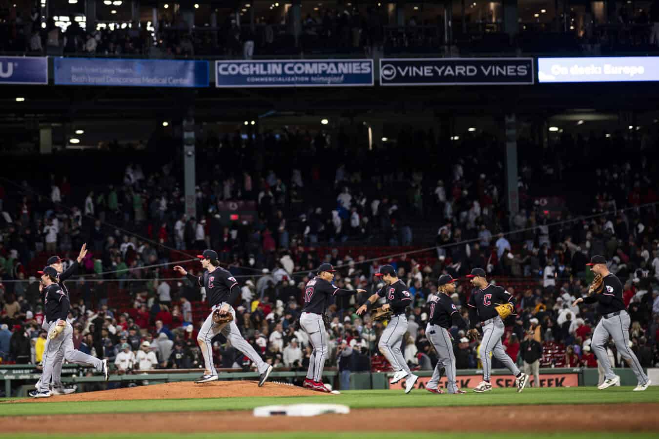 BOSTON, MASSACHUSETTS - SEPTEMBER 22: Members of the Cleveland Guardians high five after their ninth inning win over the Boston Red Sox at Fenway Park on September 22, 2026 in Boston, Massachusetts.