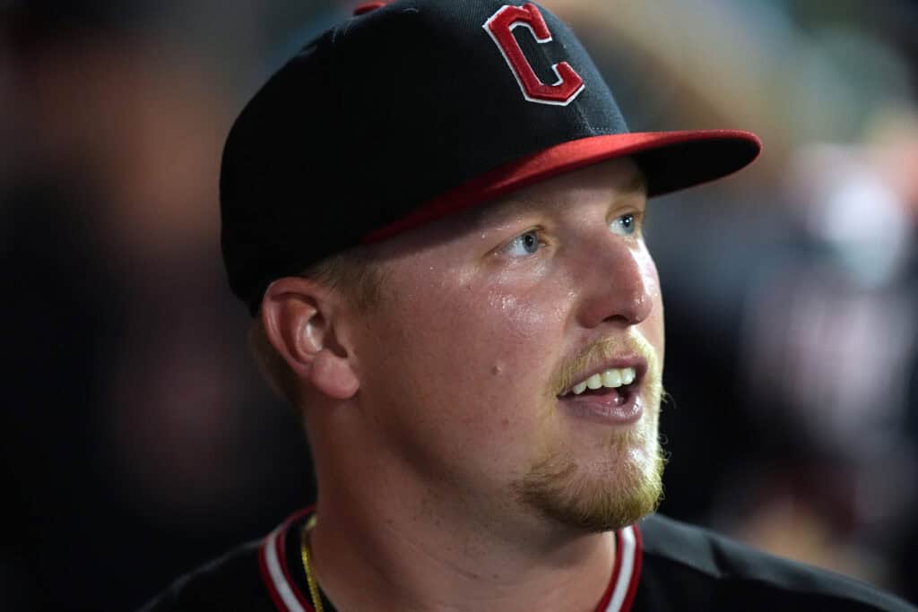 ANAHEIM, CALIFORNIA - AUGUST 24: Pitcher Parker Messick #77 of the Cleveland Guardians smiles in the dugout after retiring the Los Angeles Angels during the sixth inning of a game at Angel Stadium of Anaheim on August 24, 2026 in Anaheim, California.