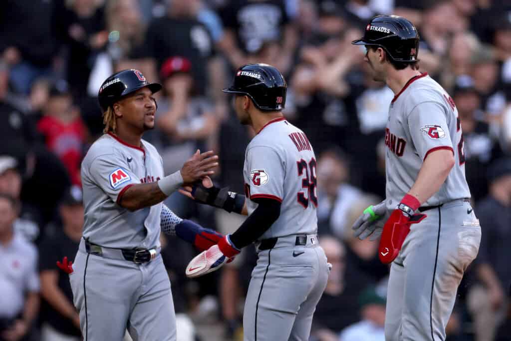 CHICAGO, ILLINOIS - OCTOBER 07: Jose Ramirez #11, Steven Kwan #38 and Chase DeLauter #24 of the Cleveland Guardians celebrate after scoring off of an RBI triple hit by Jo Adell #7 against the Chicago White Sox during the third inning in game three of the American League Division Series at Rate Field on October 07, 2026 in Chicago, Illinois.