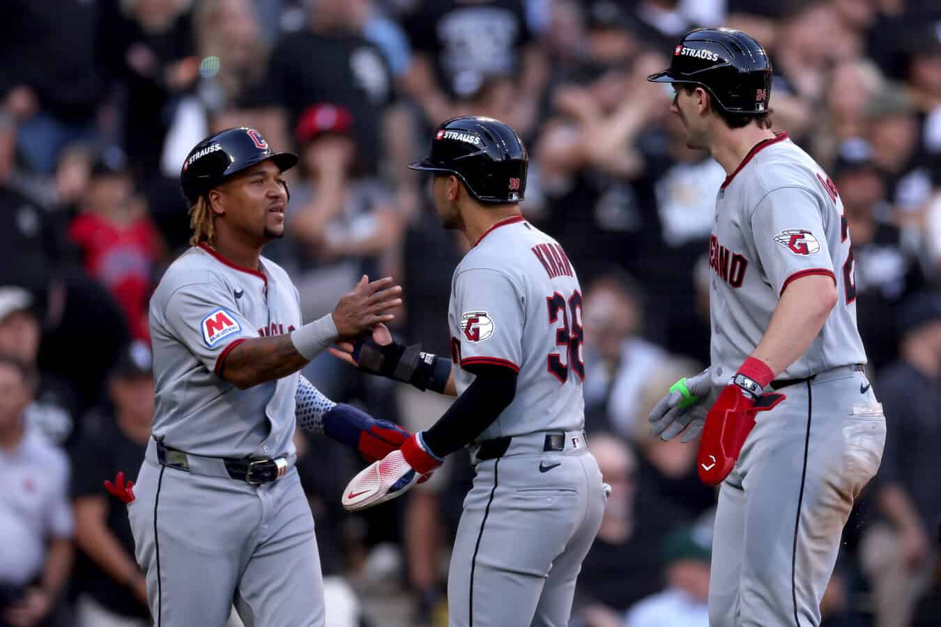 CHICAGO, ILLINOIS - OCTOBER 07: Jose Ramirez #11, Steven Kwan #38 and Chase DeLauter #24 of the Cleveland Guardians celebrate after scoring off of an RBI triple hit by Jo Adell #7 against the Chicago White Sox during the third inning in game three of the American League Division Series at Rate Field on October 07, 2026 in Chicago, Illinois.