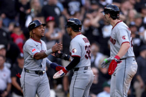 CHICAGO, ILLINOIS - OCTOBER 07: Jose Ramirez #11, Steven Kwan #38 and Chase DeLauter #24 of the Cleveland Guardians celebrate after scoring off of an RBI triple hit by Jo Adell #7 against the Chicago White Sox during the third inning in game three of the American League Division Series at Rate Field on October 07, 2026 in Chicago, Illinois.