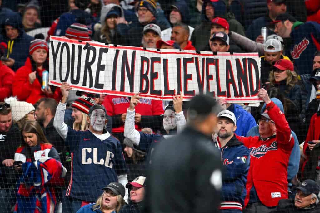 CLEVELAND, OHIO - OCTOBER 17: Fans of the Cleveland Guardians show their support by holding signs from the stands during the fifth inning against the Tampa Bay Rays in game four of the American League Championship Series at Progressive Field on October 17, 2026 in Cleveland, Ohio.