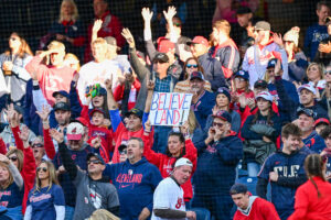 CLEVELAND, OHIO - OCTOBER 18: Fans hold signage that reads "Believe land" during the first inning as the Cleveland Guardians take on the Tampa Bay Rays in game five of the American League Championship Series at Progressive Field on October 18, 2026 in Cleveland, Ohio.