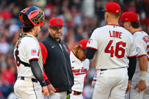 CLEVELAND, OHIO - OCTOBER 18: Manager Stephen Vogt of the Cleveland Guardians talks during a pitching change with Nathaniel Lowe #46 and Patrick Bailey #16 during the fourth inning against the Tampa Bay Rays in game five of the American League Championship Series at Progressive Field on October 18, 2026 in Cleveland, Ohio.