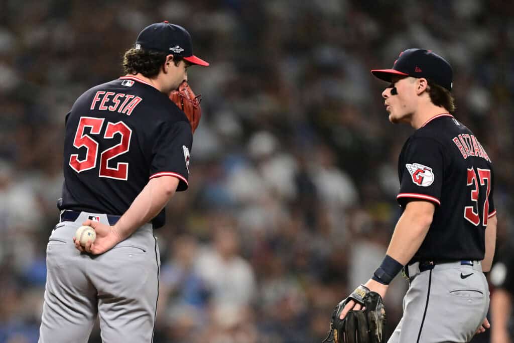 ST PETERSBURG, FLORIDA - OCTOBER 19: Matt Festa #52 of the Cleveland Guardians speaks to Travis Bazzana #37 of the Cleveland Guardians during the second inning against the Tampa Bay Rays in game six of the American League Championship Series at Tropicana Field on October 19, 2026 in St Petersburg, Florida.
