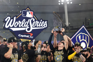 ST PETERSBURG, FLORIDA - OCTOBER 28: Cooper Pratt #12 of the Milwaukee Brewers poses with the Commissioner's Trophy after defeating the Tampa Bay Rays in the 2026 World Series at Tropicana Field on October 28, 2026 in St Petersburg, Florida.